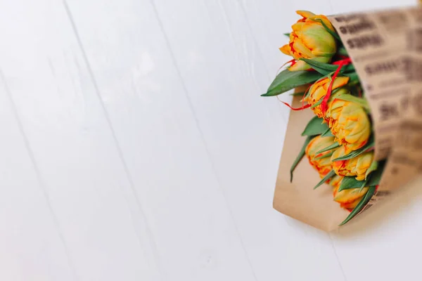 Bouquet of tulips in paper on white background — Stock Photo, Image