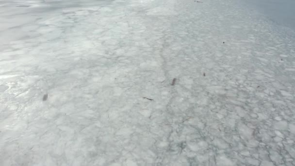 Пролетев над замерзшим льдом на водохранилище, вид сверху. Зимнее озеро. лед и мусор . — стоковое видео