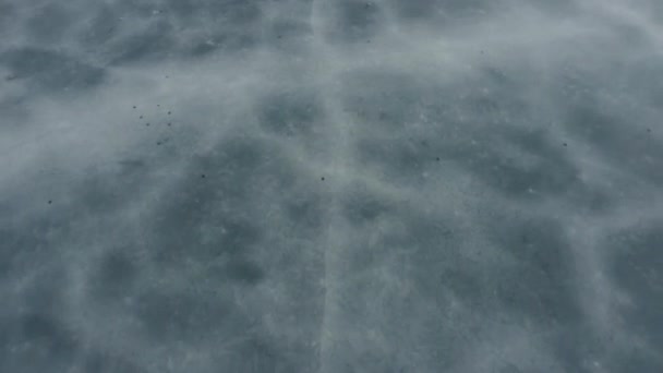 Flying over a frozen ice on a reservoir, top view. winter lake. ice and debris. — Stock Video