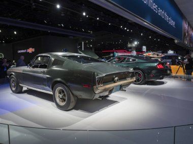 Detroit, bize - 15 Ocak 2018: Orijinal Ford Mustang Kuzey Amerika Uluslararası Otomobil Fuarı'nda şehir Detroit Cobo Center'da sırasında ekranda film Bullit'ı.