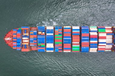 top aerial view of the large volume of TEU container on ship sailing in the sea carriage the shipment cargo from loading port to destination discharging port, transport and logistics system services to worldwide 