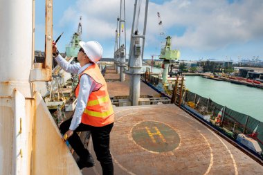 port manager, pilot or engineering foreman, supervisor, master controller in working place, walking in high level at job site, working at risk in work site