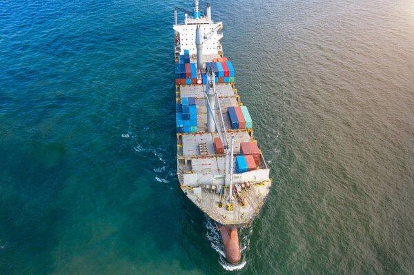 top aerial view of the containers ship sailing in the sea carriage the shipment from loading port to destination discharging port, transport and logistics services to worldwide, light and empty shipment on vovage