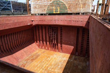 an empty cargo hole of the commercial general bulk cargo ship in cleaning and ready for bulk cargo booking for loading shipment