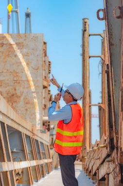 stevedore, loading master, port captain or supervisor in charge of command working on board the ship in port for safety loading discharging operation