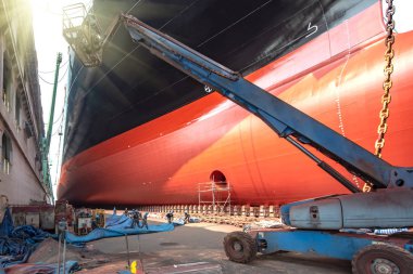 bulk head of the commercial ship in floating dry dock under recondition, painting overhaul in dock yard terminal