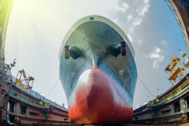 bulk head of the commercial ship sitting on the supporter in floating dry dock yard