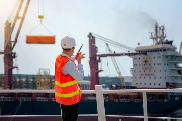 stevedore, loading master, port captain or supervisor in charge of command working on board the ship in port for safety loading discharging operation