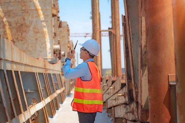stevedore, loading master, port captain or supervisor in charge of command working on board the ship in port for safety loading discharging operation