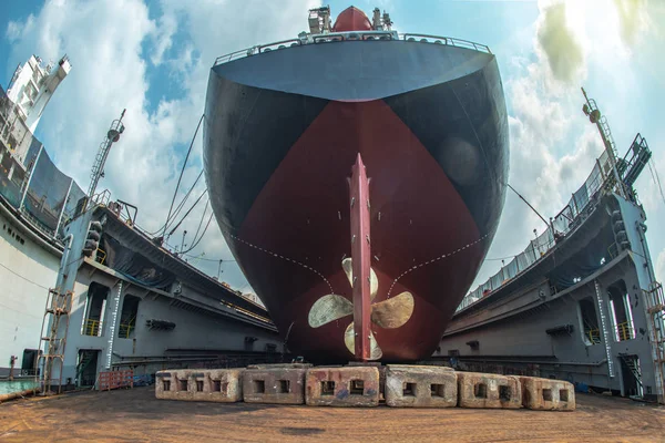 aft stern of the commercial ship in floating dry dock, painting , repairing, recondition of overhaul, ship sitting on supporter bottom of dry dock terminal