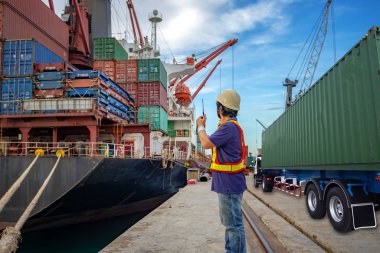 the loading and discharging operation container ship vessel in port takes control by stevedore and foreman in charge, working in port terminal being for logistics and transport services to worldwide