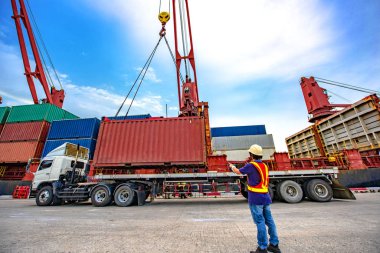 the loading and discharging operation container ship vessel in port takes control by stevedore and foreman in charge, working in port terminal being for logistics and transport services to worldwide
