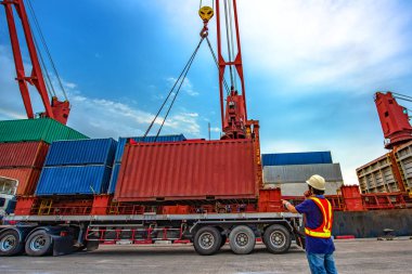 the loading and discharging operation container ship vessel in port takes control by stevedore and foreman in charge, working in port terminal being for logistics and transport services to worldwide