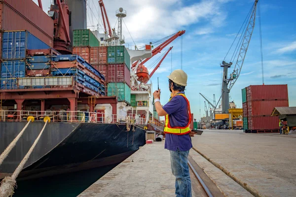 the loading and discharging operation container ship vessel in port takes control by stevedore and foreman in charge, working in port terminal being for logistics and transport services to worldwide