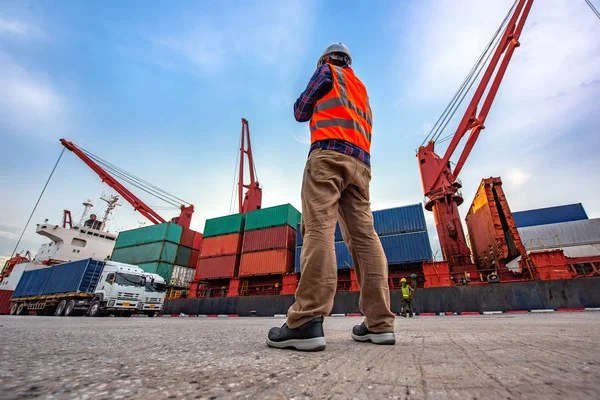 the loading and discharging operation container ship vessel in port takes control by stevedore and foreman in charge, working in port terminal being for logistics and transport services to worldwid