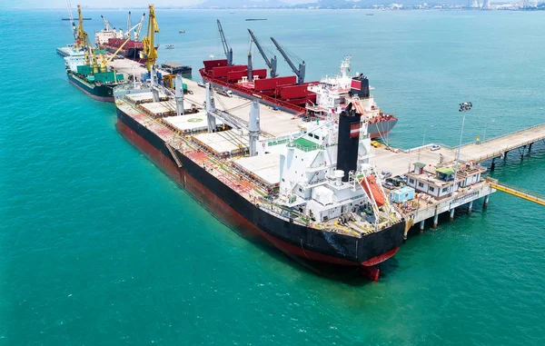 top view; aerial view of sea port terminal keep busy with bulk cargo ships working operation of loading and discharging shipment and cargo transition