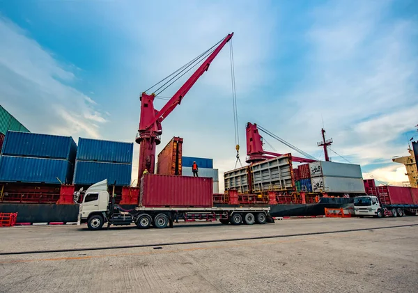 container unit delivery from yard by the trailer trucking to the ship in port terminal for loading by the ship crane, the services of logistics and transport shipment to worldwide global
