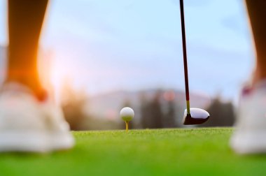 golf ball laying on wooden tee, prepare and ready to hit the ball to the destination target