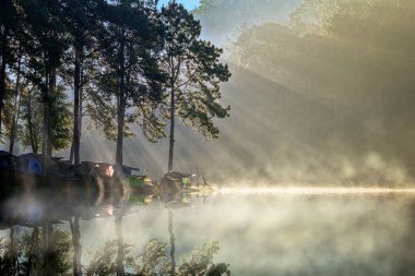 The morning nature of foggy and mist flowing on above the lake river creek in the Countryside, Pang Oung the popular place for tourist in Northern part of Thailand clipart