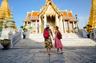 Tayland, Zümrüt Buda Tapınağı, Wat Phra Kaew, Bangkok Kraliyet Sarayı popüler turizm merkezi Bangkok 'taki saray tapınağında yürüyen genç turist kadınlar.