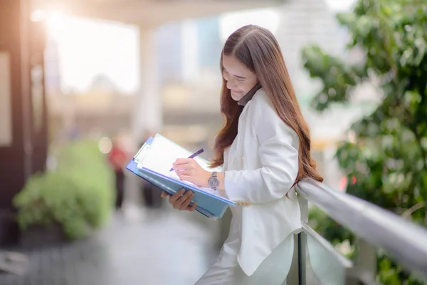 working woman in busy of involve business on street of city town, working online anytime and anywhere to reach customer satisfy