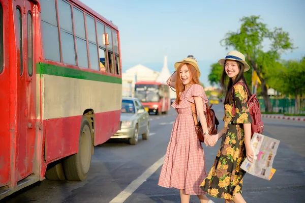 tourist women are going to get in Bus in Bangkok, traveling in urban bus city visit capital of Thailand