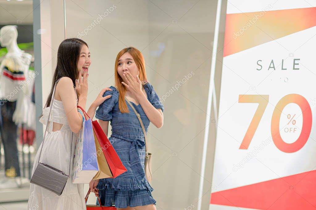 happy women and joyful and exciting in shopping mall center, buying and shopping consumerism with many bags holding in hands