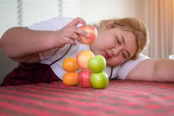 plump fatty woman anti and refused to eat fruit on table, do not wants to eat fresh salad, against fresh fruit, un-preferable fruit sala