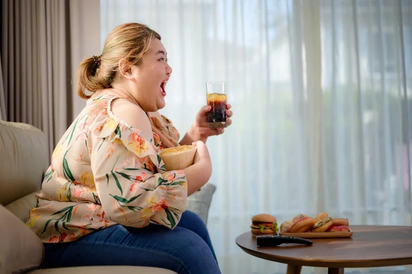 plump fatty woman hunger enjoy eating a lot junk food with high calories beverage drink in hand, happy eating woman