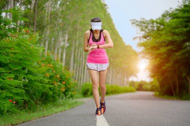 woman runner set the running watch to concentrate rate of heart timing for review health