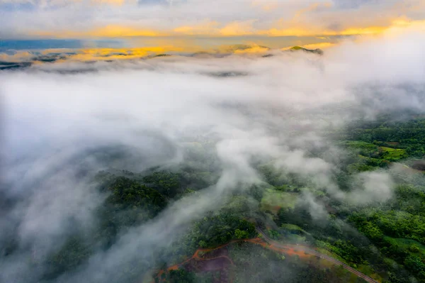 aerial top view of the mist step over flow cover from mountain to the village in Countryside