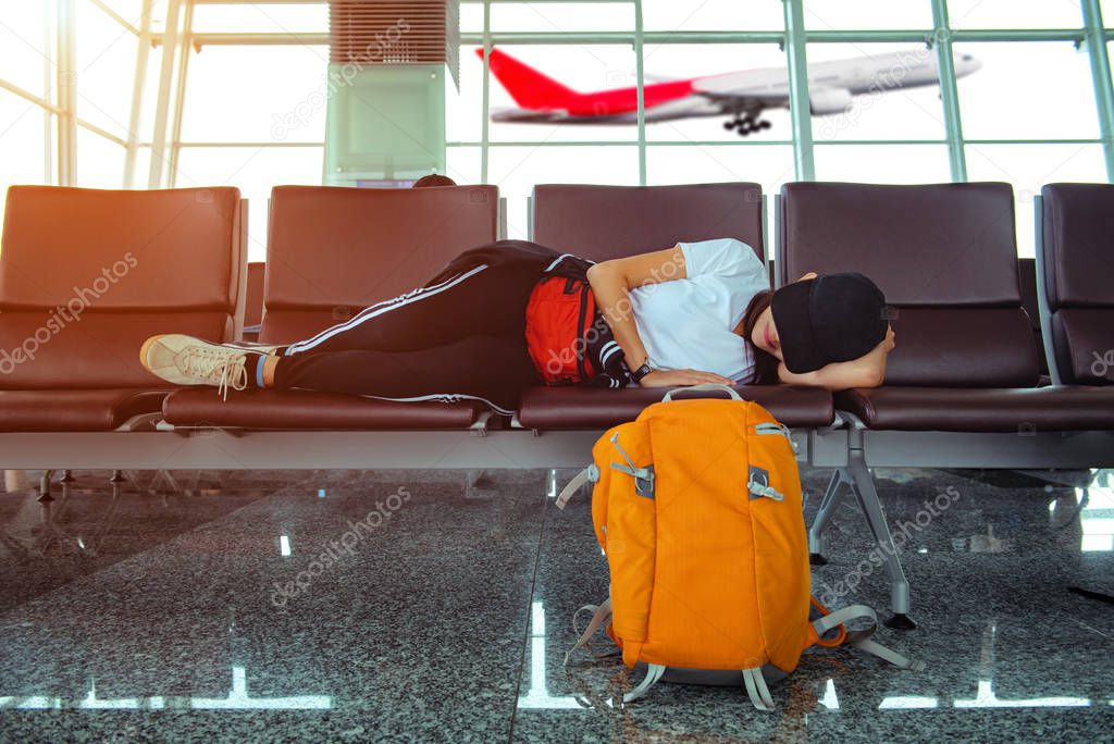 woman lost flight at coming late to checking in boarding pass to the airline gate, sleep on the chair waiting for next flight booking progress 