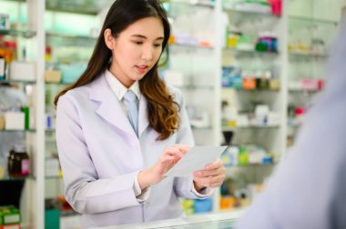 hand of woman phamacist holding prescription of medicine and explain property of medicine to patient or buyer customer how to apply