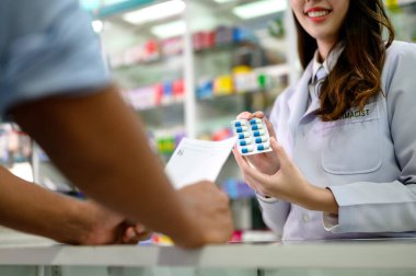 medicine bundle in hands of selling pharmacist offer to man customers buying in drug store, prescription order pills instruct by doctor specialist