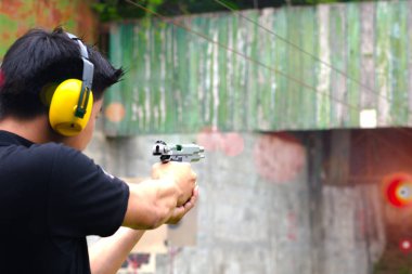 shot gun magazine in hand of man is reflect in flicking after shooting bullet away to the target, effective against weight of gun recoil spring works after shooting by stable action