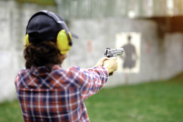 Short magazine gun in hand of old woman being for practice on arm and weapon martial art for woman