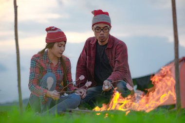 couple lover enjoy camping at the night inside tent, countryside traveling of the couple lover, campfire enjoyin