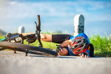 accident clashed on young woman bicyclist in hurt and injured at knee of leg, after accident clashed, laying down on the street in suffering of hurt and injured