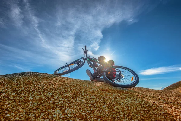 cyclist mountain bike in an accident on the hill rocky after jumping on the race competitive