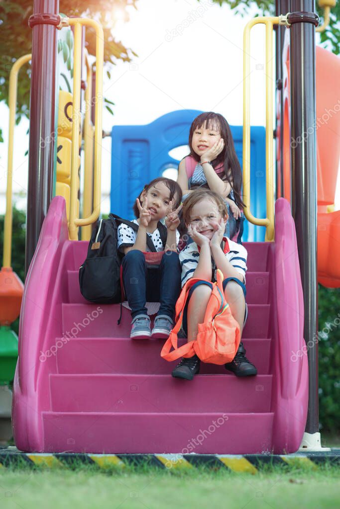 group of international kids preschool enjoy playing in schoolyard together