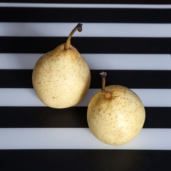 Two pears on a black and white striped napkin — Stock Photo, Image