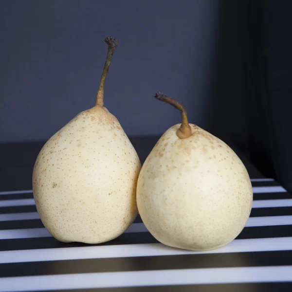 Two pears on a black and white striped napkin — Stock Photo, Image