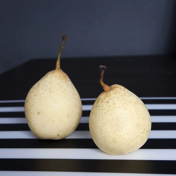 Two pears on a black and white striped napkin — Stock Photo, Image