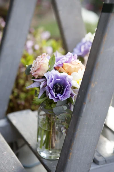 Rosa, manzanilla, eucalipto, anémona, freesia en frasco de vidrio en las escaleras —  Fotos de Stock