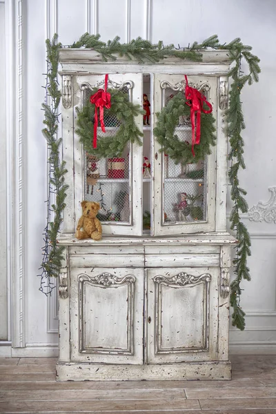 Wardrobe with Christmas toys and Christmas tree garland — Stock Photo, Image