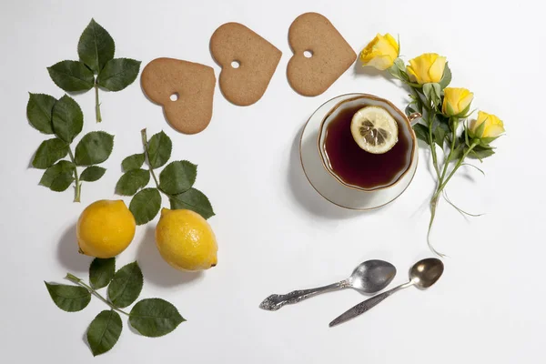 Ornament of lemons, cookies and rose leaves on white background. Recipe of gingerbread — Stock Photo, Image