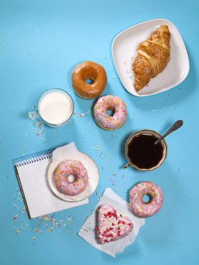 ideal breakfast for the proper energy for the full day. Fresh coffee with milks and donuts . Hipster pictures. Top view clipart