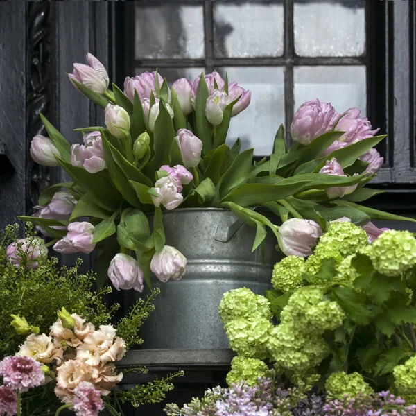 A Large bouquets of tulips, lilacs and lily buds for sale on the — Stock Photo, Image