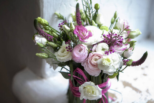 the Spring bouquet of pink Ranunculus, lisianthus and Veronica f