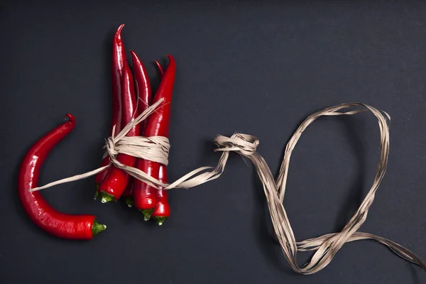 The Postcards for recipes. Red chile pepper, tied with twine, on a gray napkin. Copy space Stock Image